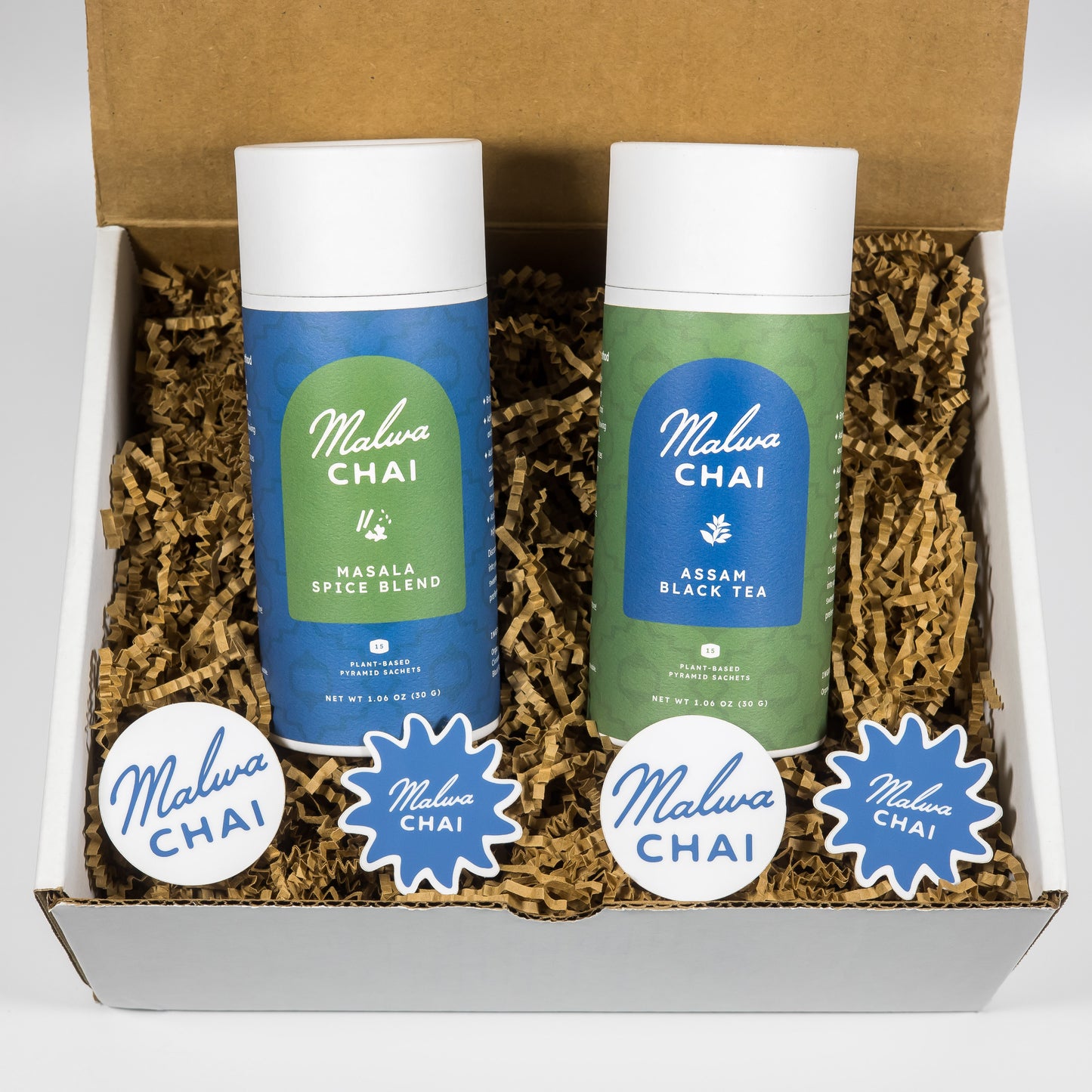 Two bottles of Malwa Chai tea in a box with decorative paper.